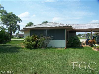 1602 Ridgecrest Street Lehigh Acres, FL 33936 - Photo 2 of 12 a view of a house with a garden