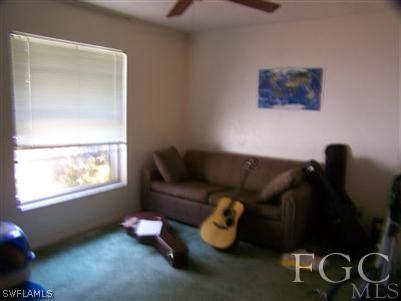 1602 Ridgecrest Street Lehigh Acres, FL 33936 - Photo 6 of 12 a living room with furniture and a window