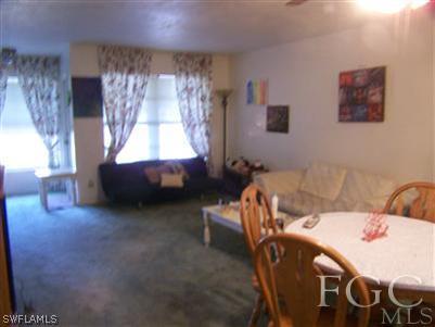 1602 Ridgecrest Street Lehigh Acres, FL 33936 - Photo 7 of 12 a bed room with a bed and a chair
