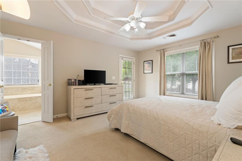 878 Scales Road Suwanee, GA 30024 - Photo 10 of 17 a bedroom with a bed a flat screen tv and dresser