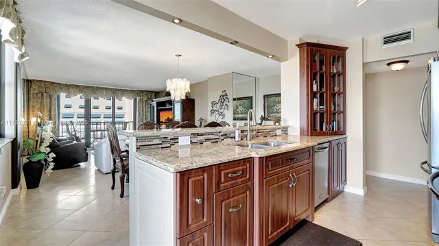 a kitchen with stainless steel appliances granite countertop a refrigerator sink and cabinets