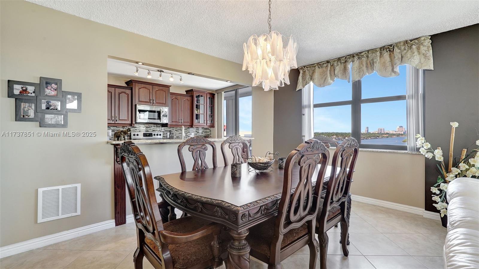 322 Buchanan Street, Unit 907 Hollywood, FL 33019 - Photo 17 of 45 a view of a dining room with furniture window and wooden floor