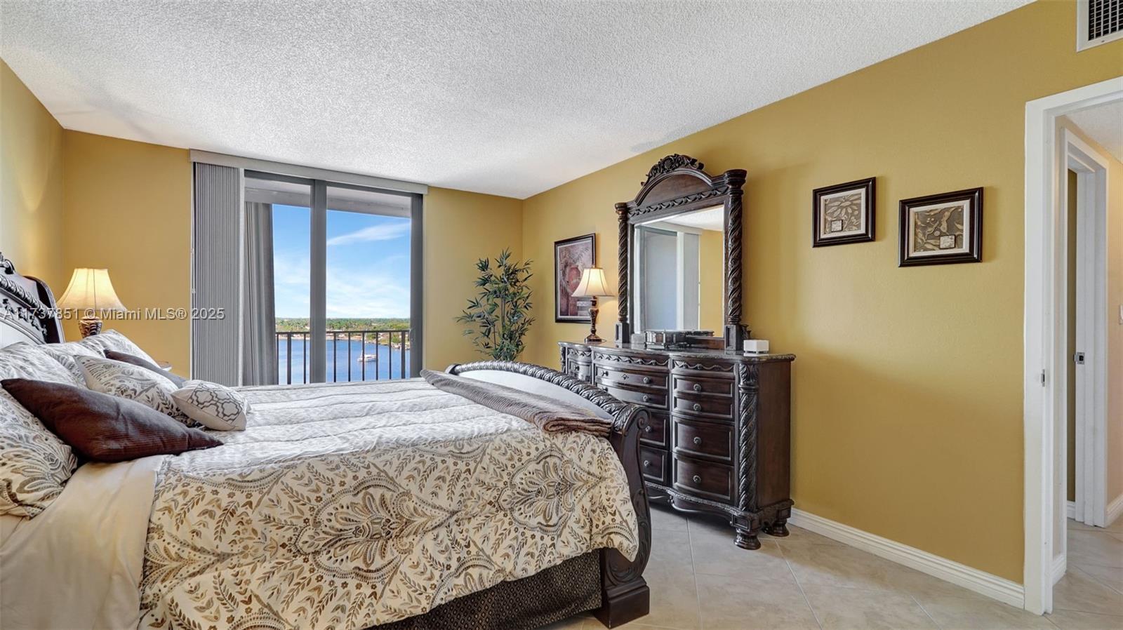 322 Buchanan Street, Unit 907 Hollywood, FL 33019 - Photo 26 of 45 a bedroom with a bed and a dresser