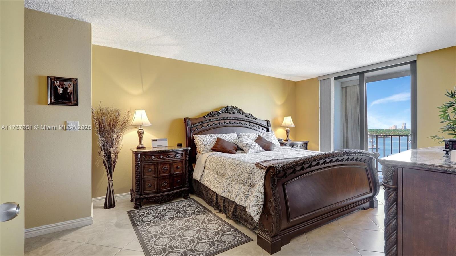 322 Buchanan Street, Unit 907 Hollywood, FL 33019 - Photo 27 of 45 a bedroom with a bed and wooden floor