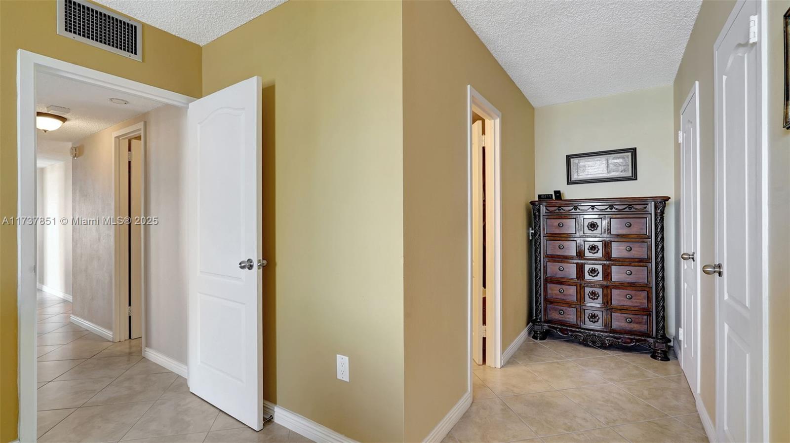 322 Buchanan Street, Unit 907 Hollywood, FL 33019 - Photo 29 of 45 a view of a hallway with wooden shelves and closet