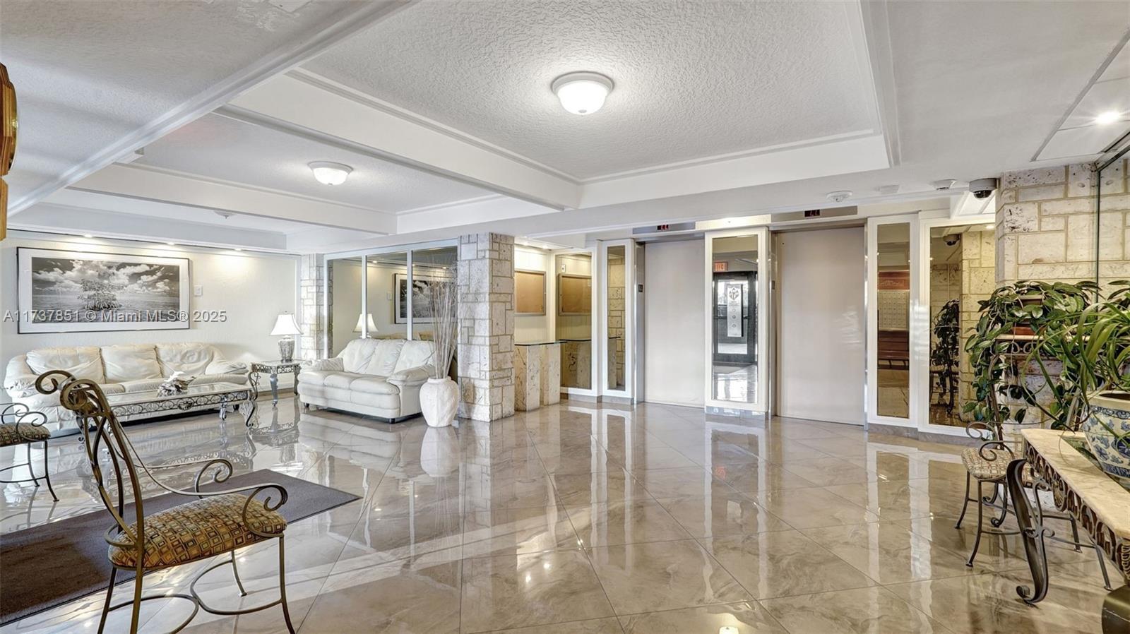 322 Buchanan Street, Unit 907 Hollywood, FL 33019 - Photo 33 of 45 a living room with furniture and potted plants with wooden floor