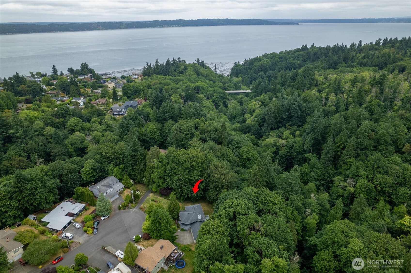 0 Agnes Road Northeast Tacoma, WA 98422 - Photo 2 of 21 a view of a lake with a house in a yard