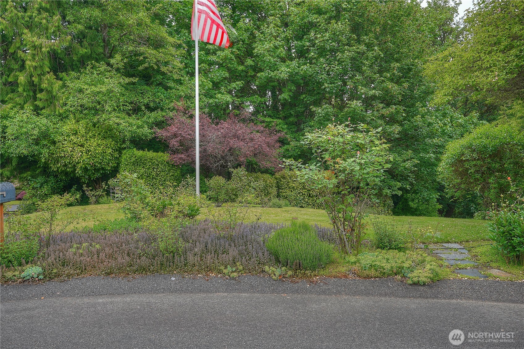 0 Agnes Road Northeast Tacoma, WA 98422 - Photo 4 of 21 a flag is sitting in the middle of a yard