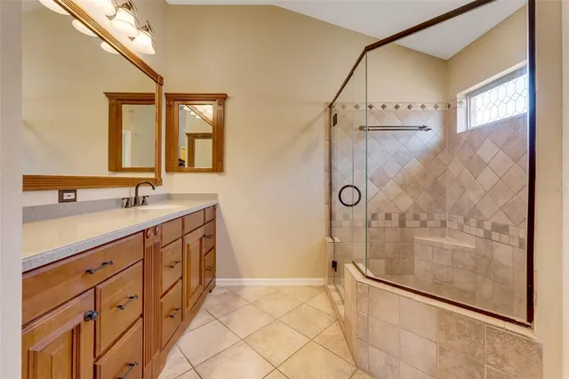 a bathroom with a glass shower door