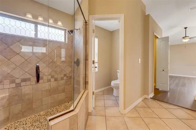 a spacious bathroom with 2 sink and a mirror