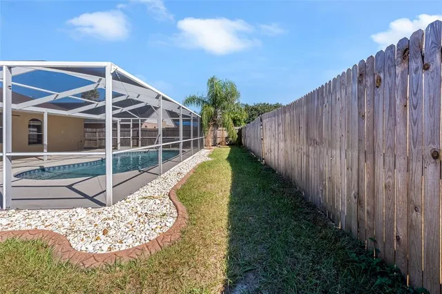 a view of a house with a backyard and a small yard