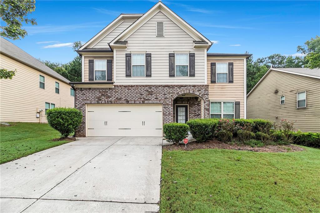 a front view of a house with a yard