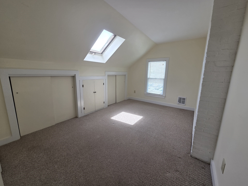 14 Hawkes Street, Unit 2 Marblehead, MA 01945 - Photo 4 of 12 an empty room with a empty space and windows