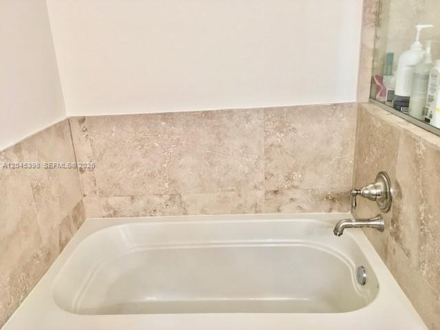 3232 Southwest 22nd Terrace, Unit 1303 Miami, FL 33145 - Photo 21 of 43 a bathroom with a bathtub