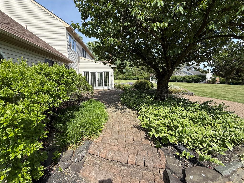 4114 Rochelle Drive Allentown, PA 18104 - Photo 2 of 35 A winding brick pathway leads through established landscaping to the home's sun-filled rear entrance.