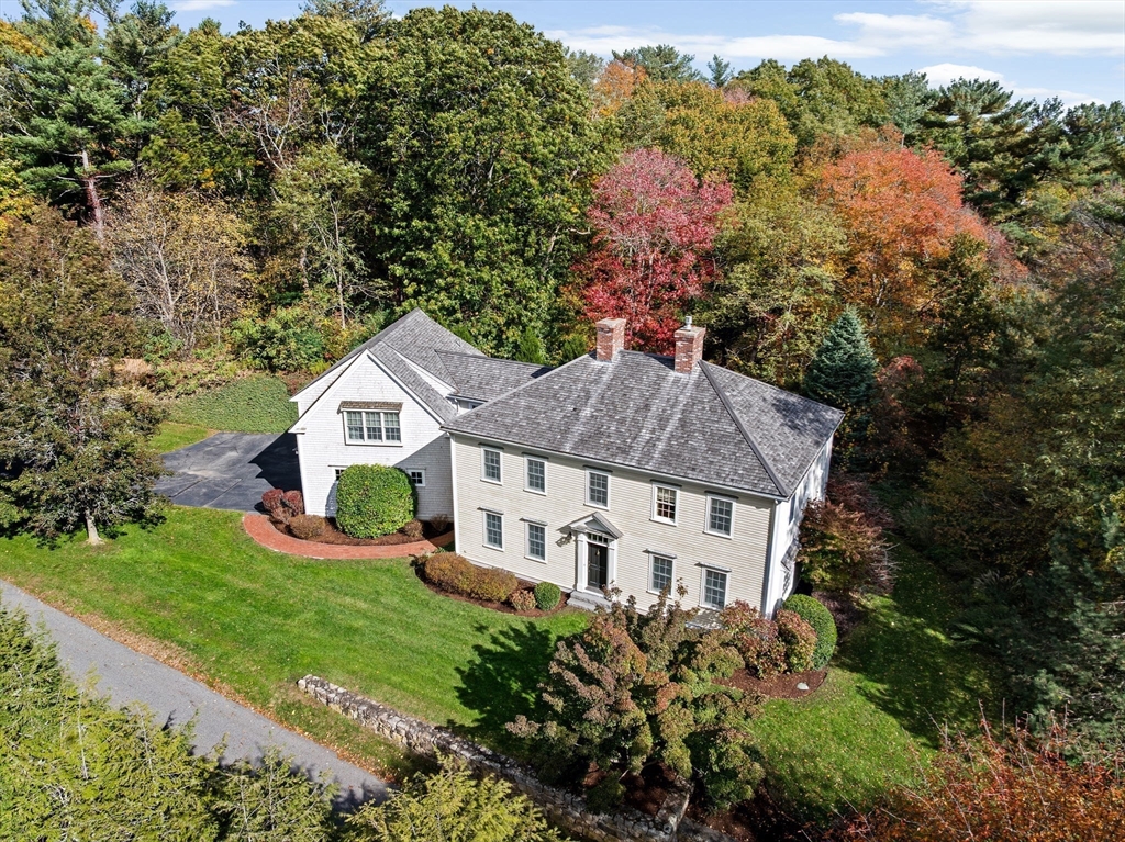 an aerial view of a house with a yard