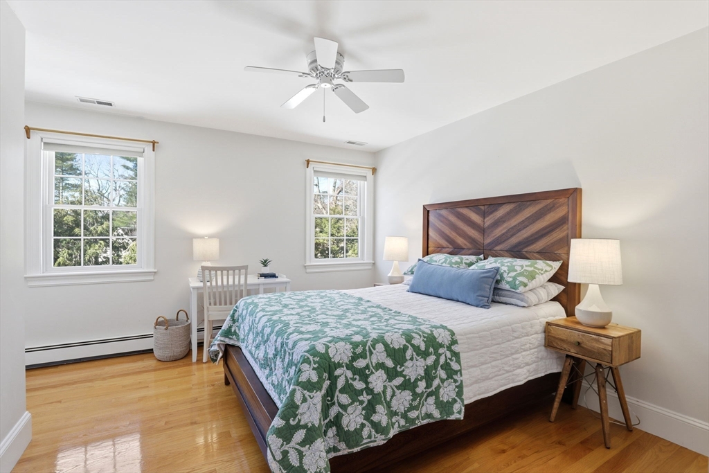 138 Judge Cushing Road Scituate, MA 02066 - Photo 19 of 40 a bedroom with a bed and a chandelier