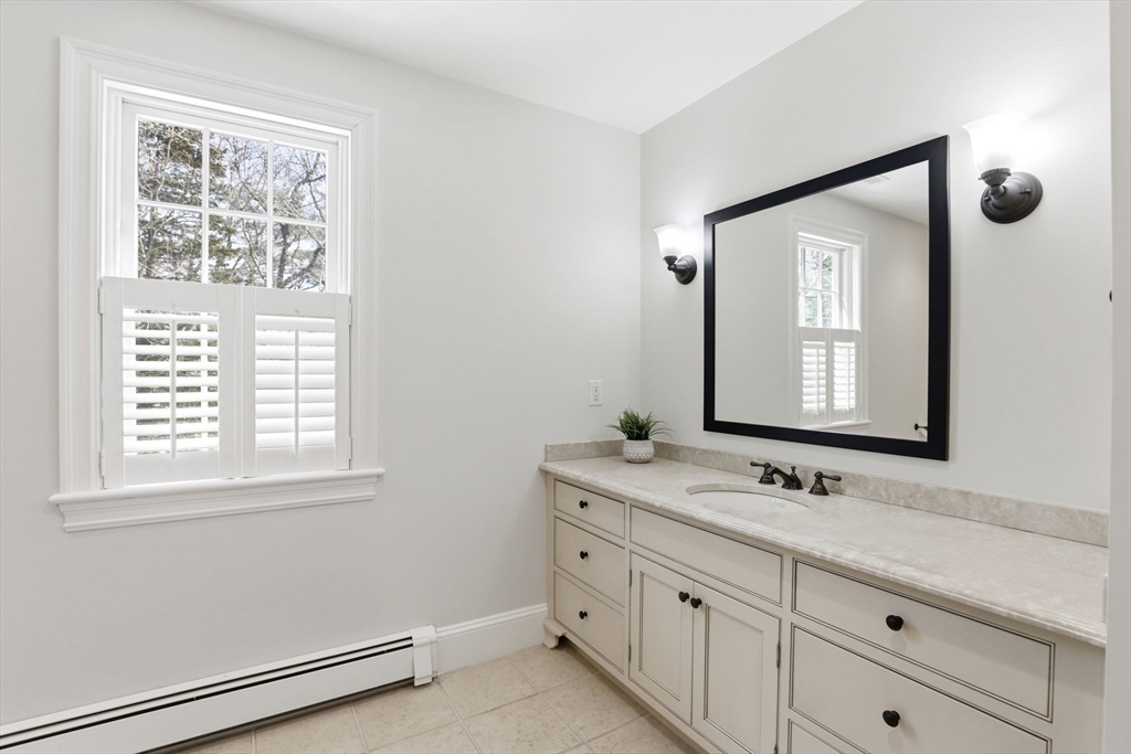 138 Judge Cushing Road Scituate, MA 02066 - Photo 22 of 40 a bathroom with a sink vanity and a mirror