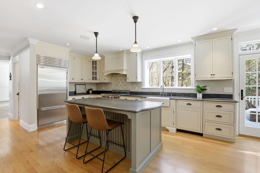 138 Judge Cushing Road Scituate, MA 02066 - Photo 3 of 40 a kitchen with kitchen island granite countertop a sink cabinets and window