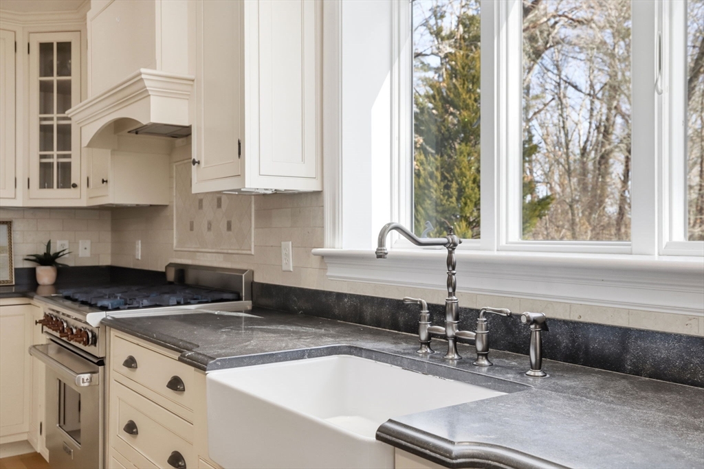 138 Judge Cushing Road Scituate, MA 02066 - Photo 7 of 40 a kitchen with granite countertop a sink and a stove next to a window