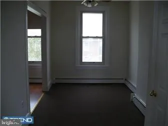 a view of an empty room and a window