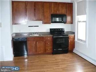 a kitchen with granite countertop a stove and a microwave