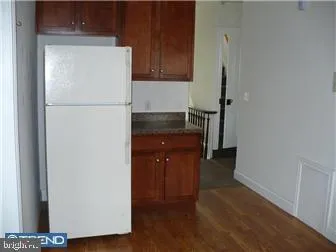 a kitchen with a refrigerator and a stove