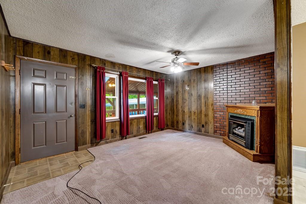 302 Mitchell Road Sylva, NC 28779 - Photo 16 of 48 a view of an empty room with a fireplace and a window