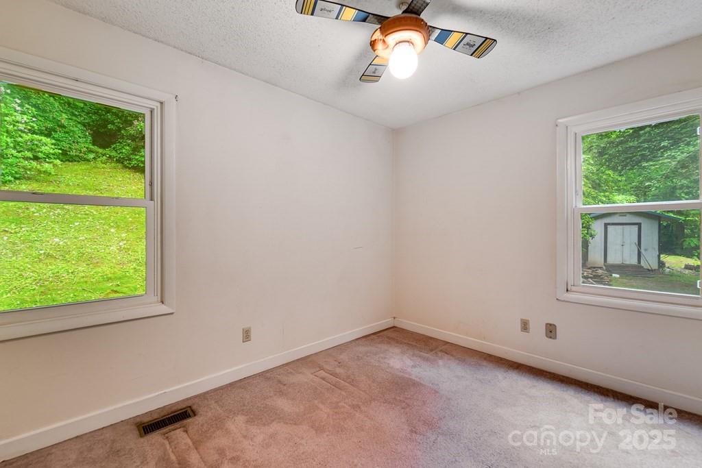 302 Mitchell Road Sylva, NC 28779 - Photo 25 of 48 a view of an empty room with a window