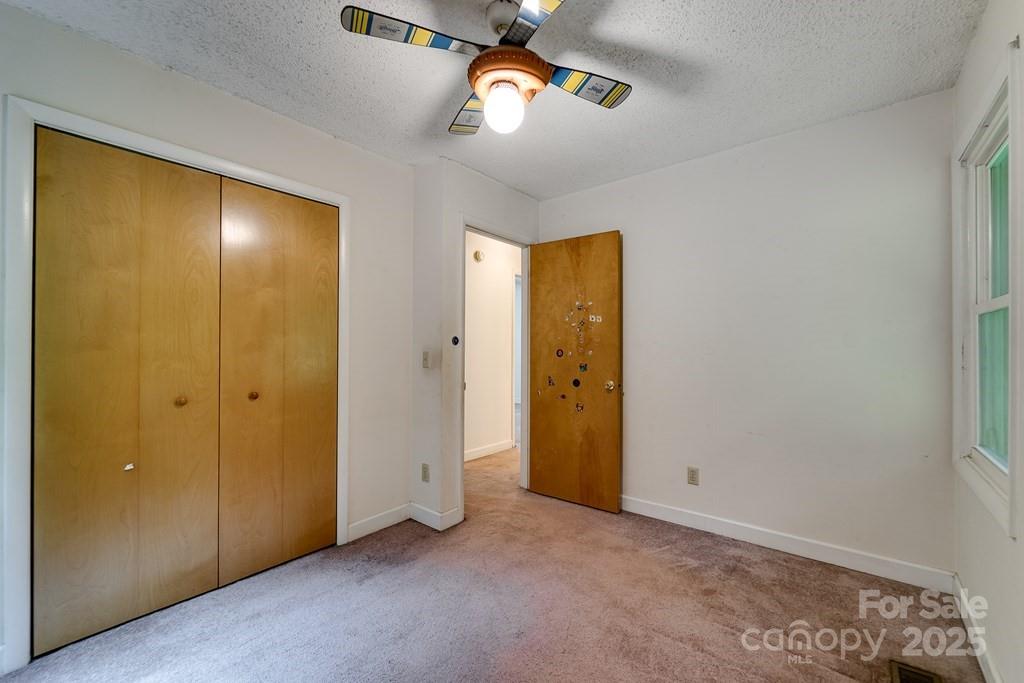 302 Mitchell Road Sylva, NC 28779 - Photo 26 of 48 a view of an empty room with a window and fire place