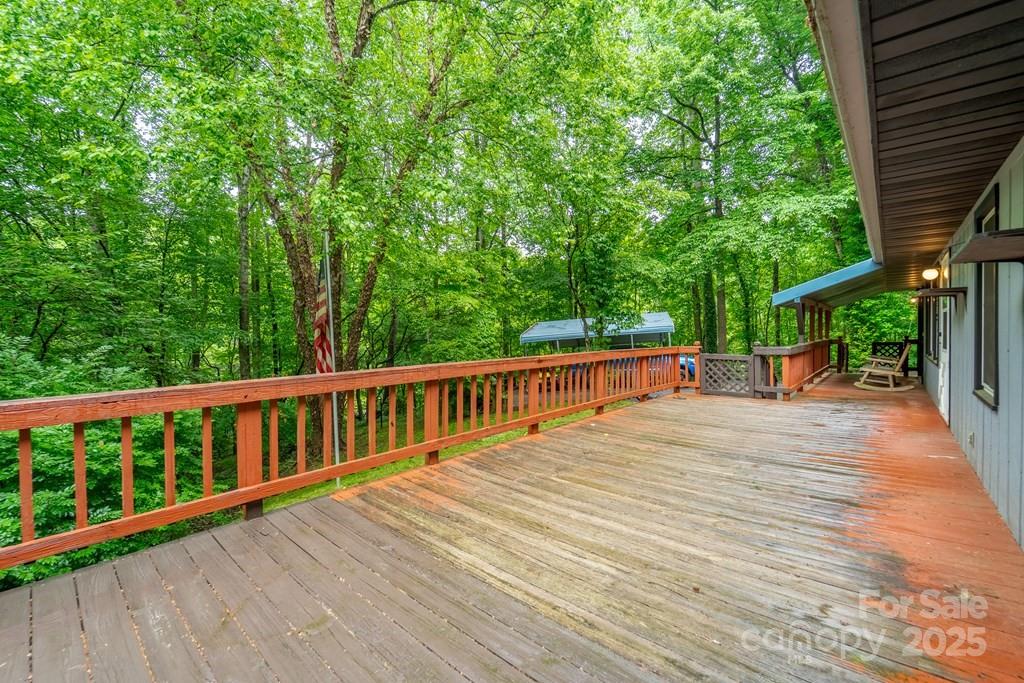 302 Mitchell Road Sylva, NC 28779 - Photo 33 of 48 a view of a deck with chairs a barbeque with wooden floor and fence