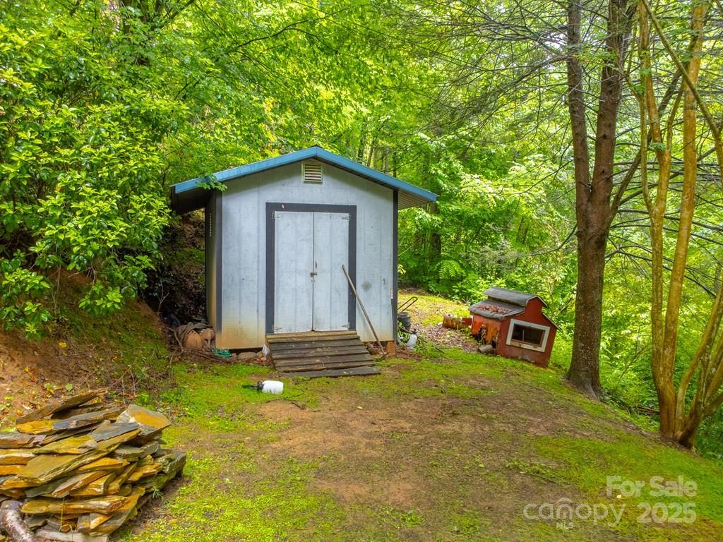 302 Mitchell Road Sylva, NC 28779 - Photo 45 of 48 a view of backyard with a barn and large trees