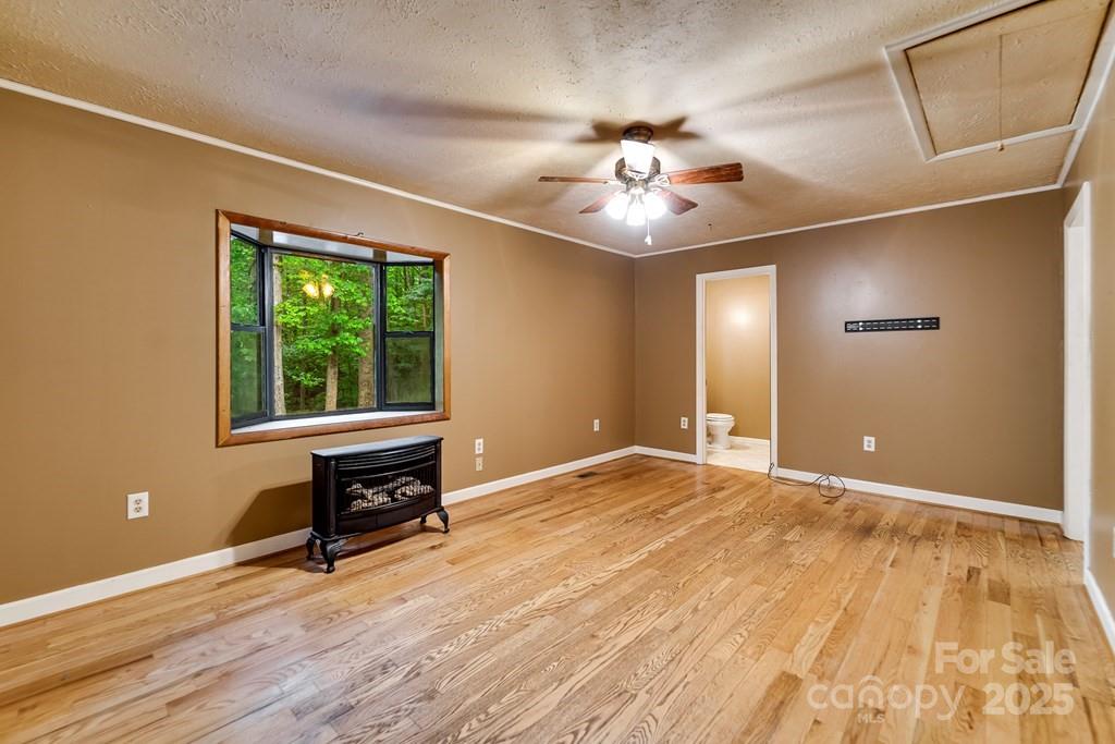 302 Mitchell Road Sylva, NC 28779 - Photo 6 of 48 a view of an empty room with a window and wooden floor