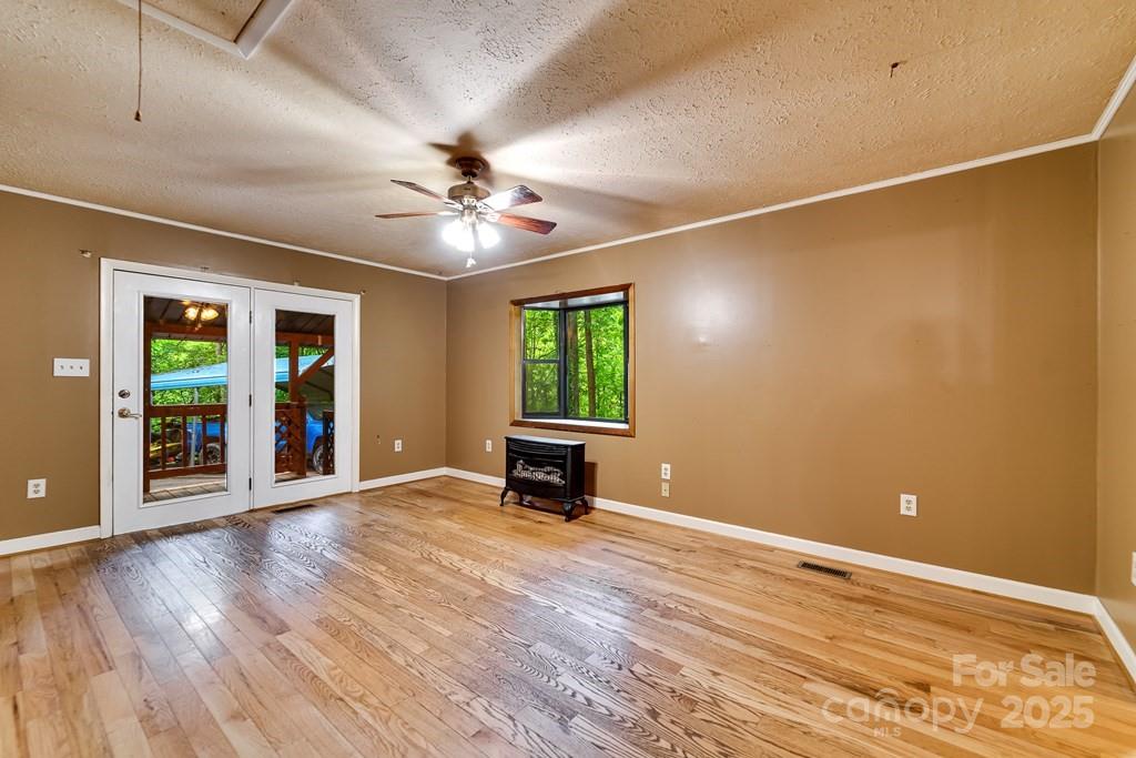 302 Mitchell Road Sylva, NC 28779 - Photo 7 of 48 a view of an empty room with a window and wooden floor