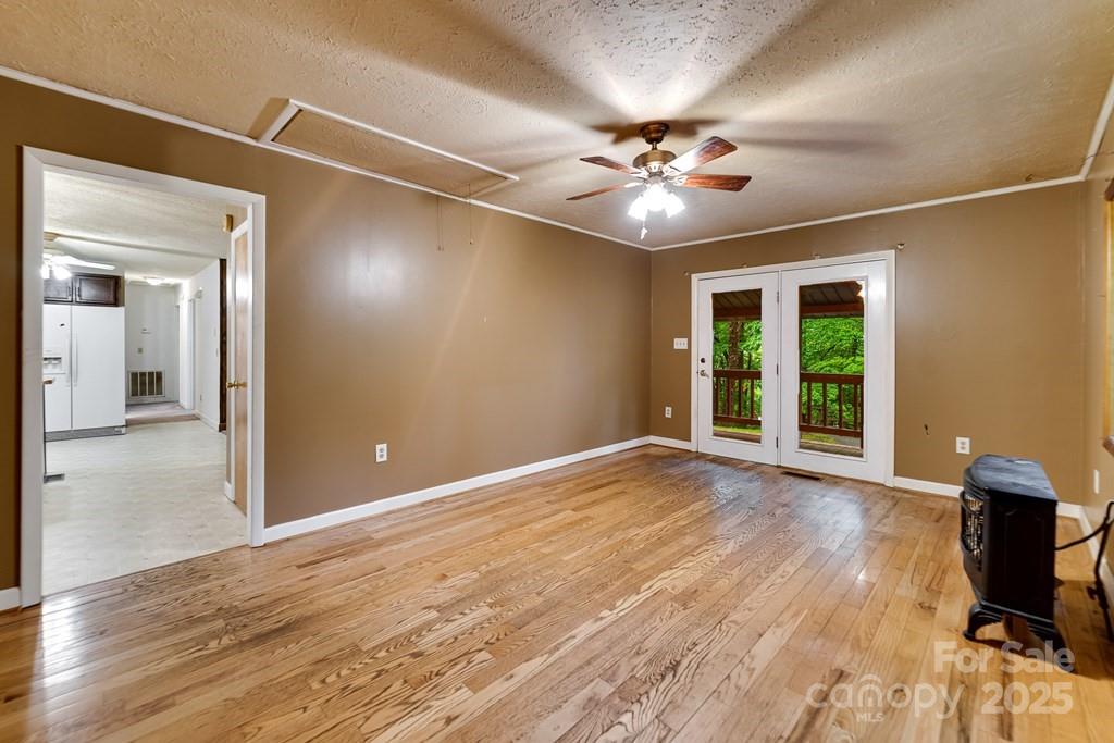 302 Mitchell Road Sylva, NC 28779 - Photo 8 of 48 a view of an empty room with wooden floor and a window
