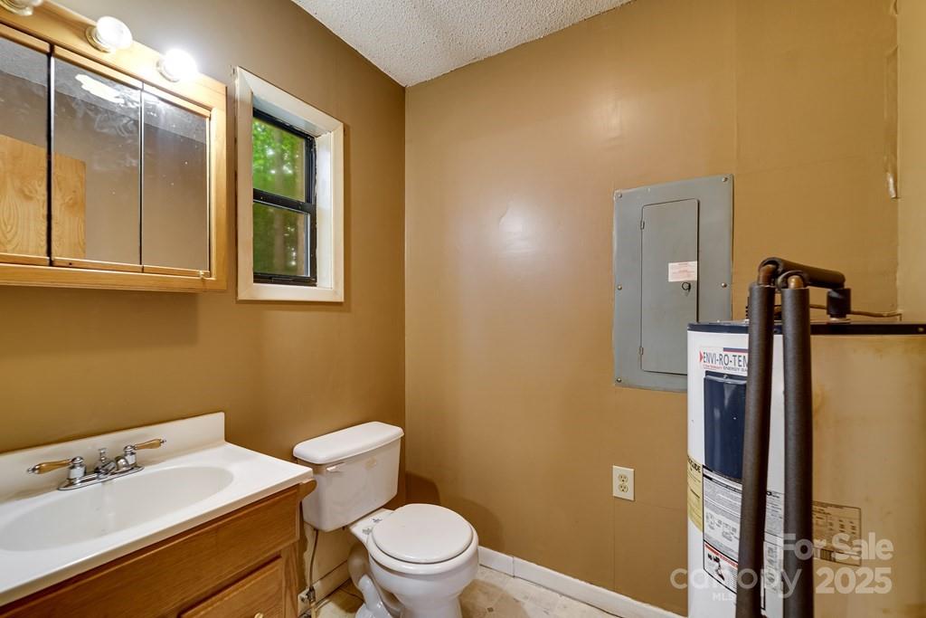 302 Mitchell Road Sylva, NC 28779 - Photo 9 of 48 a bathroom with a sink a toilet and a mirror