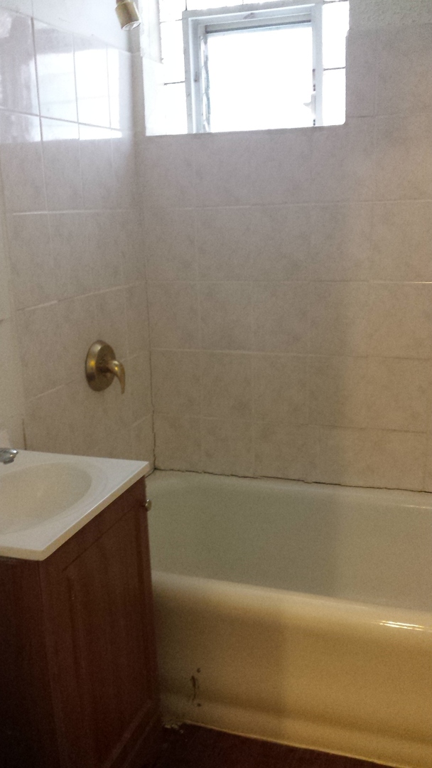5304 West Division Street, Unit G Chicago, IL 60651 - Photo 5 of 5 a bathroom with a sink and a bathtub
