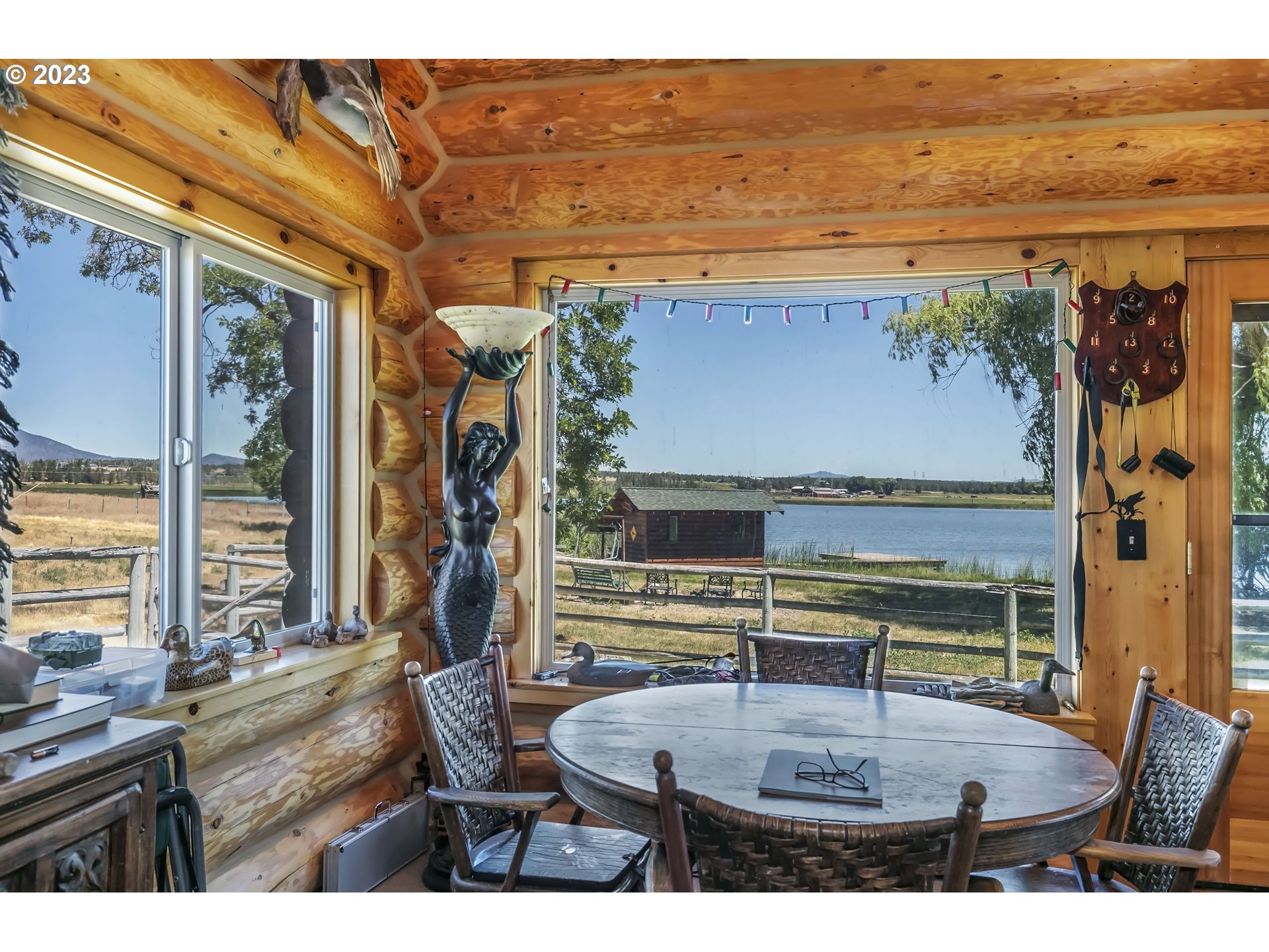 11677 Southwest Houston Lake Road Powell Butte, OR 97753 - Photo 11 of 35 a living room with furniture and a floor to ceiling window