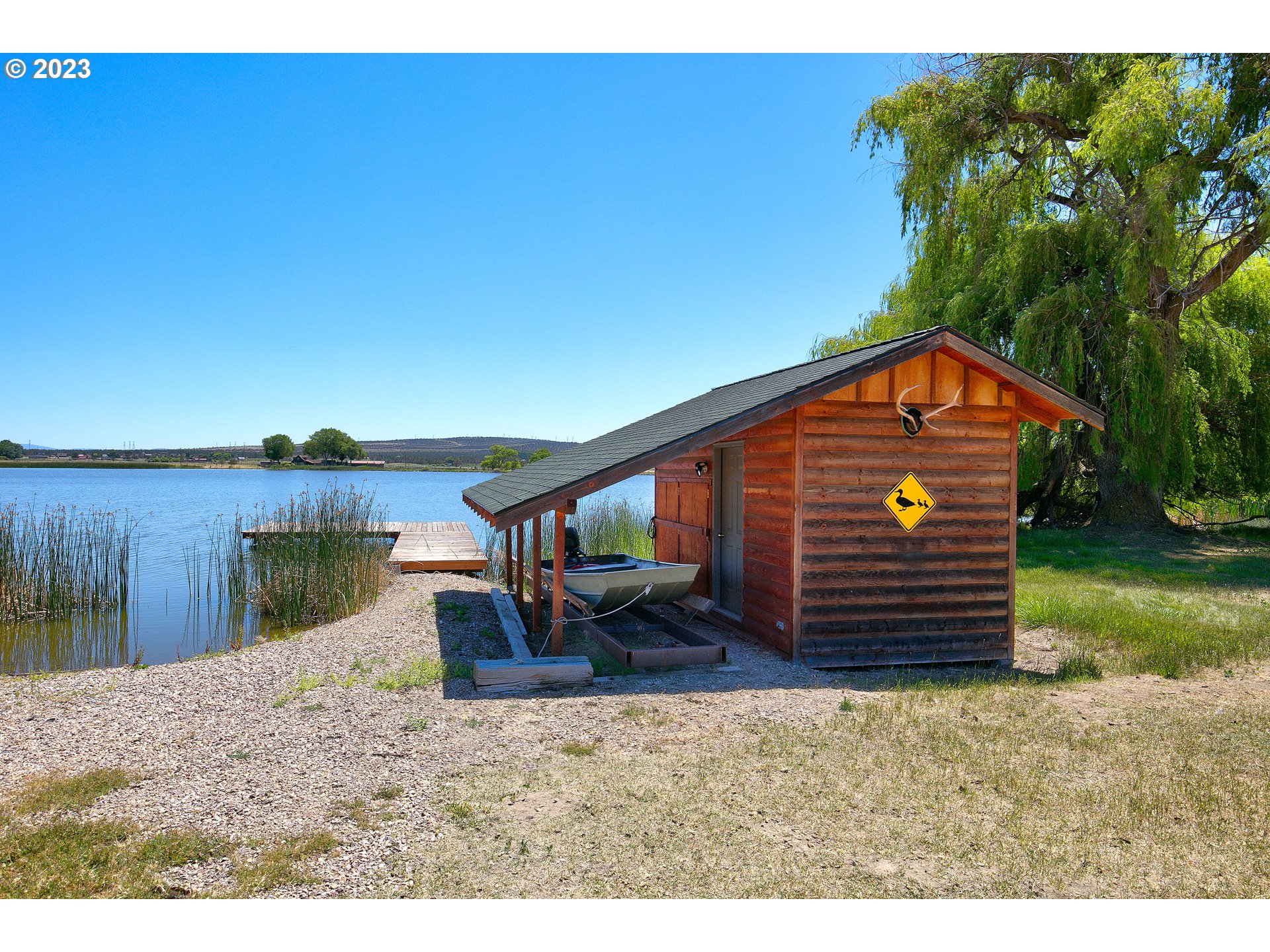 11677 Southwest Houston Lake Road Powell Butte, OR 97753 - Photo 13 of 35 a backyard of a house with wooden fence