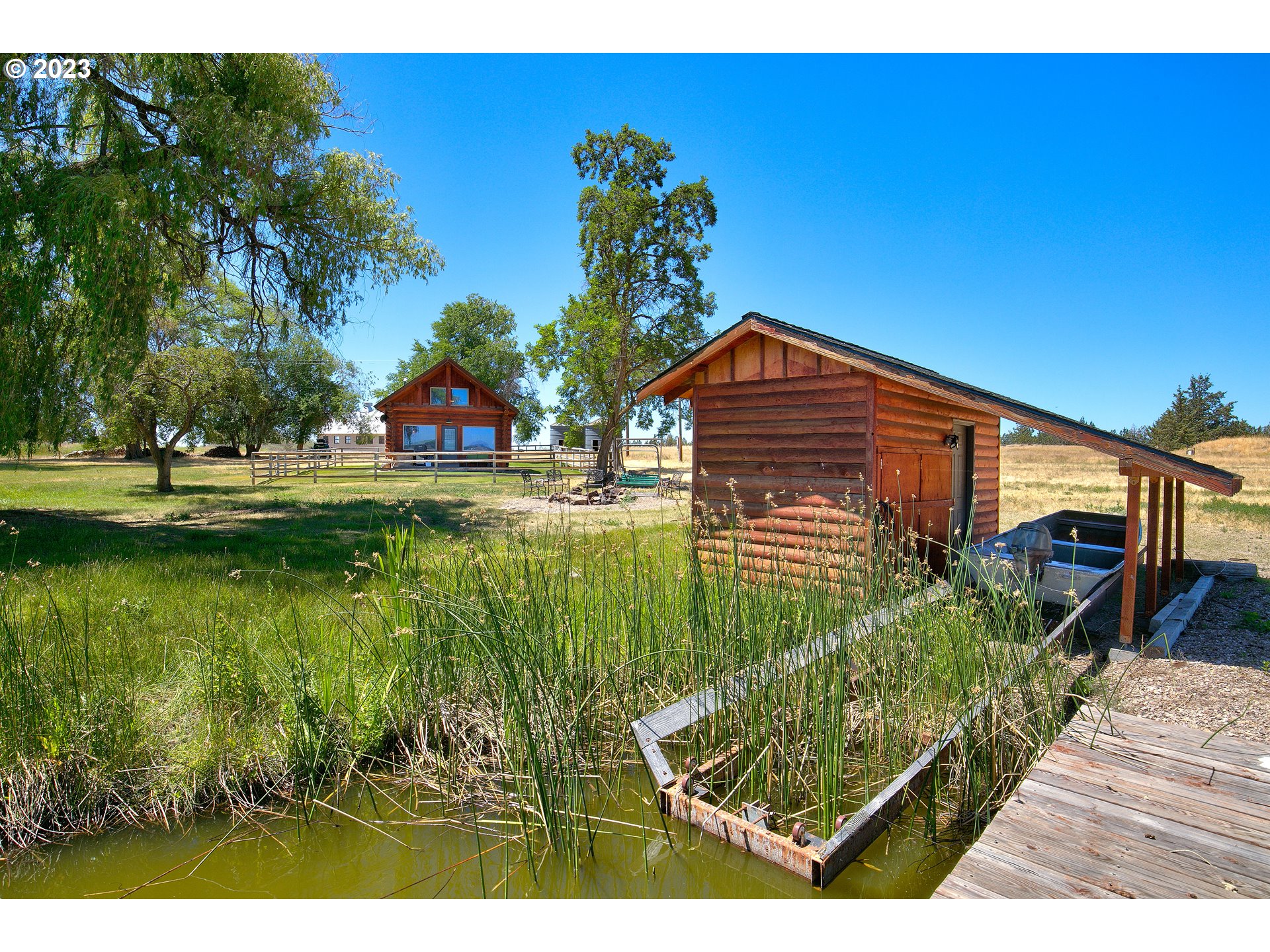 11677 Southwest Houston Lake Road Powell Butte, OR 97753 - Photo 14 of 35 a view of a house with a yard
