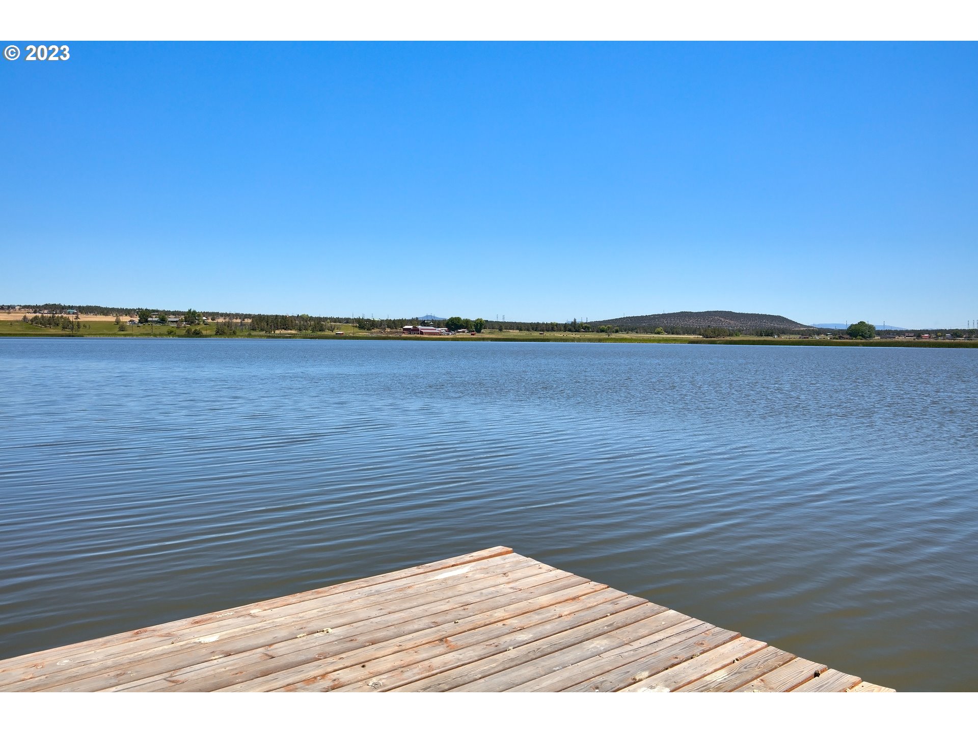 11677 Southwest Houston Lake Road Powell Butte, OR 97753 - Photo 16 of 35 a wooden floor and lake view