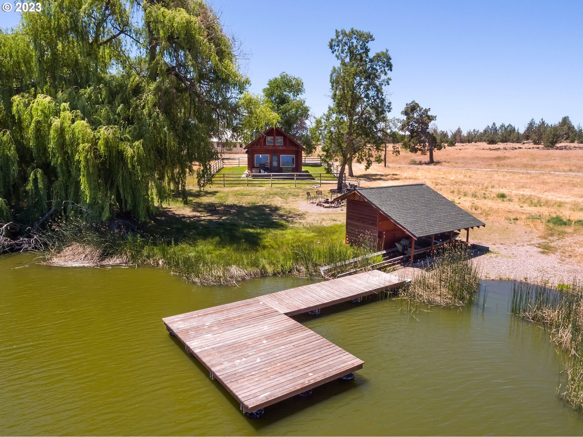 11677 Southwest Houston Lake Road Powell Butte, OR 97753 - Photo 18 of 35 a view of an ocean with a house in the background