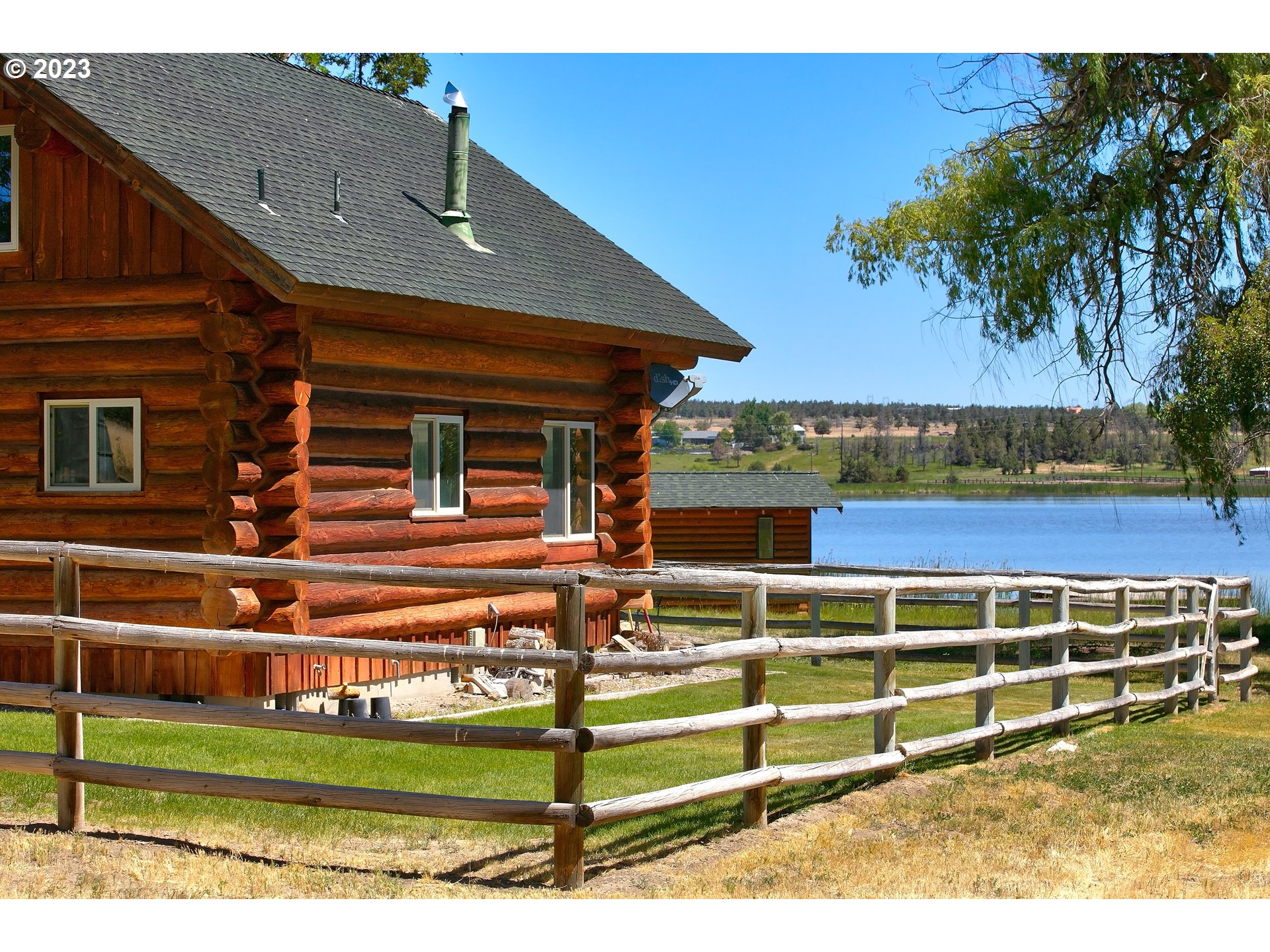 11677 Southwest Houston Lake Road Powell Butte, OR 97753 - Photo 3 of 35 a view of a house with a yard