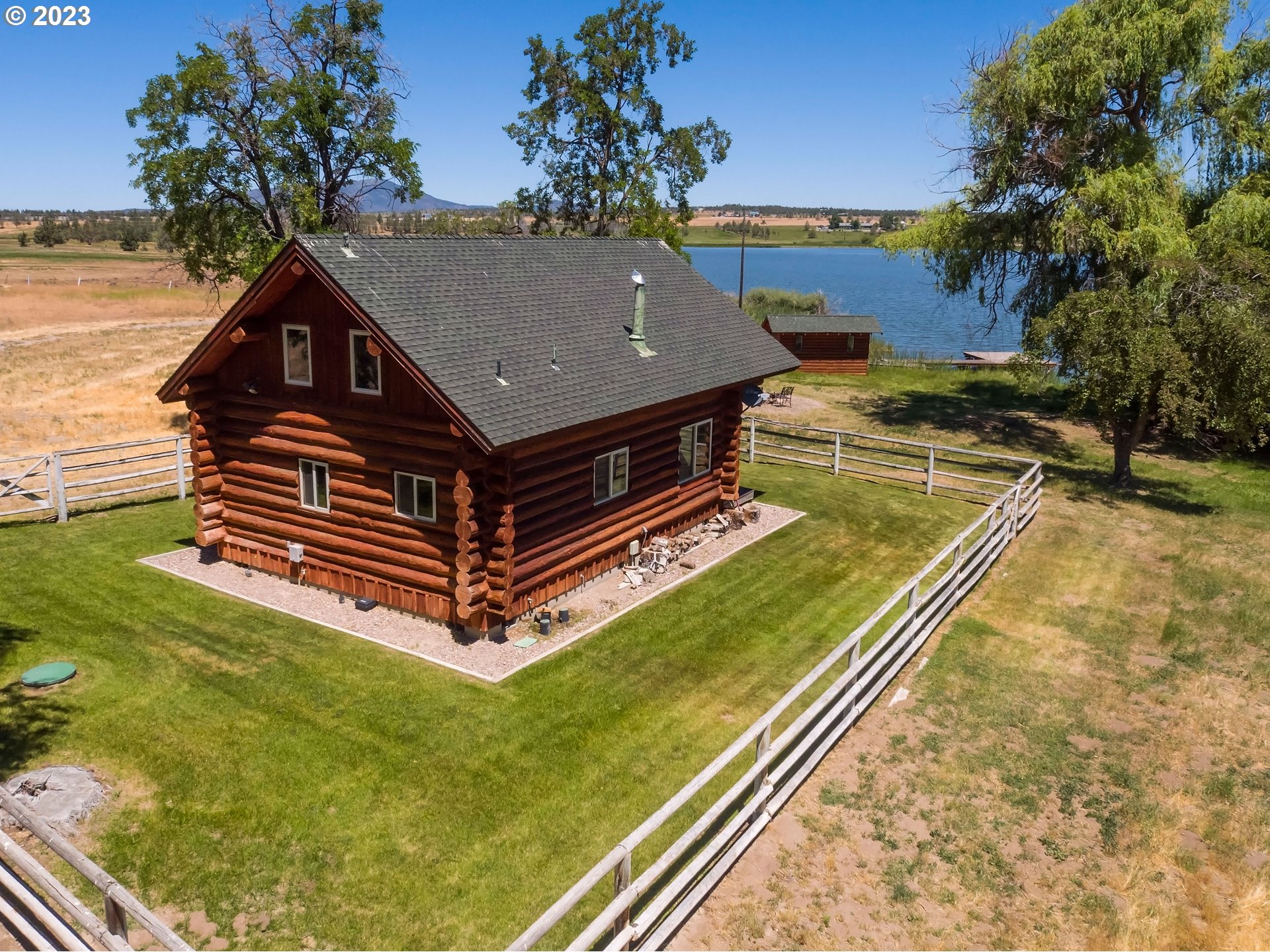 11677 Southwest Houston Lake Road Powell Butte, OR 97753 - Photo 33 of 35 a wooden bench sitting in the middle of a park