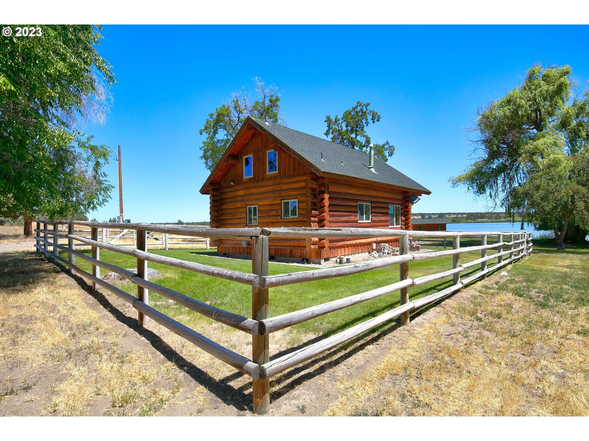 11677 Southwest Houston Lake Road Powell Butte, OR 97753 - Photo 4 of 35 a view of a house with a yard