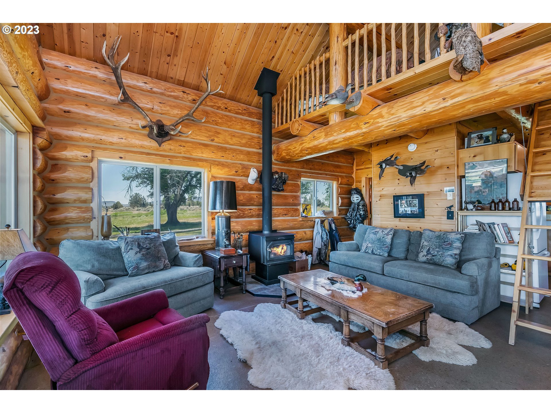 11677 Southwest Houston Lake Road Powell Butte, OR 97753 - Photo 8 of 35 a living room with furniture a fireplace and a flat screen tv