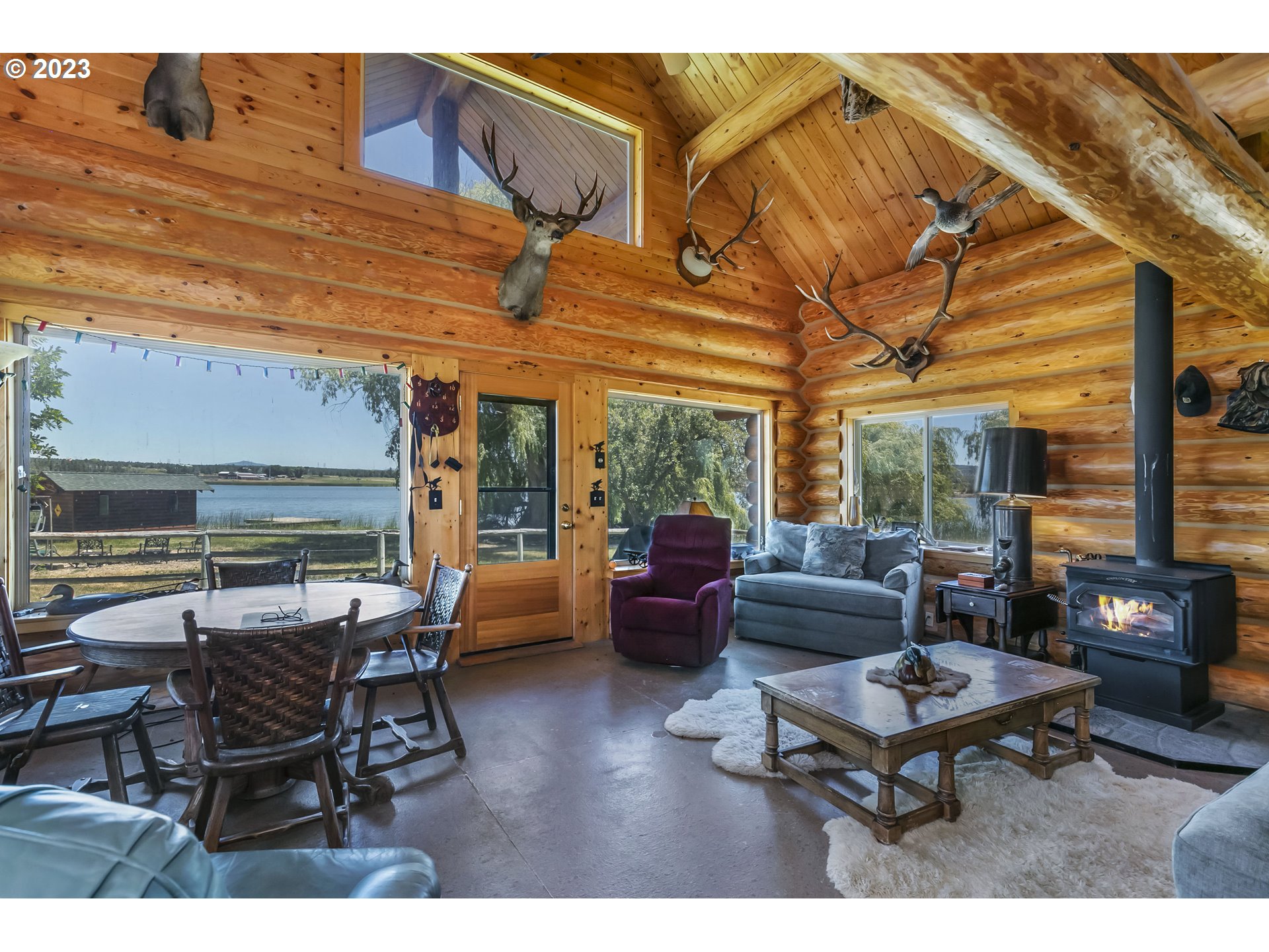 11677 Southwest Houston Lake Road Powell Butte, OR 97753 - Photo 9 of 35 a living room with furniture a table and wooden floor
