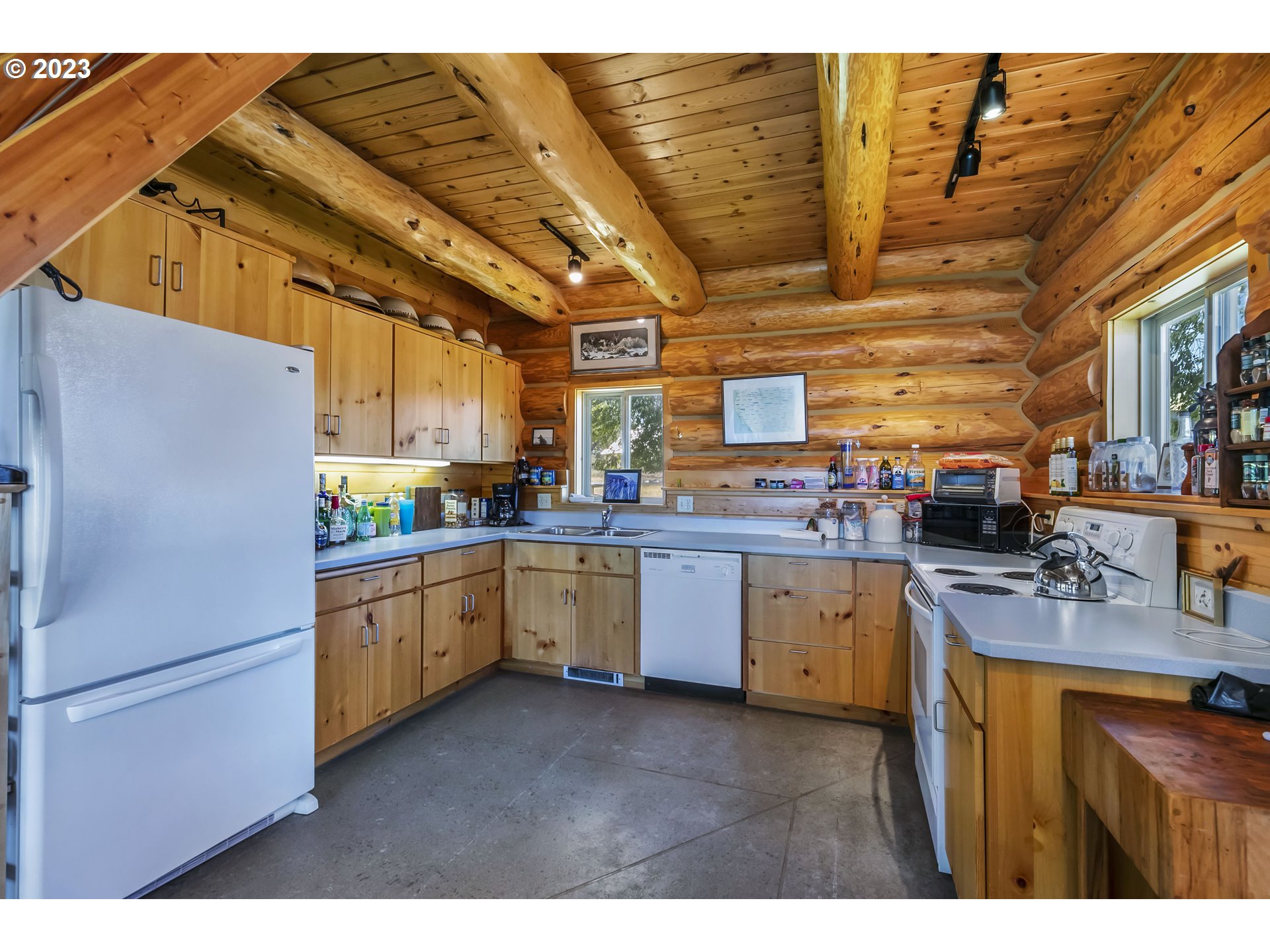 11677 Southwest Houston Lake Road Powell Butte, OR 97753 - Photo 10 of 35 a kitchen with cabinets appliances and a counter