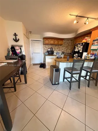 a view of a backyard with a table and chairs