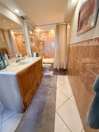a bathroom with a sink a toilet and a shower